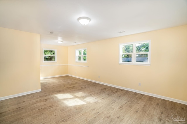 spare room with light hardwood / wood-style flooring and plenty of natural light