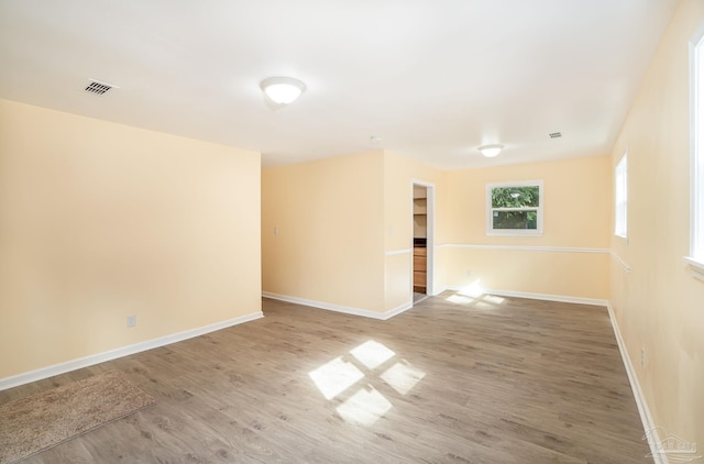 unfurnished room with hardwood / wood-style flooring