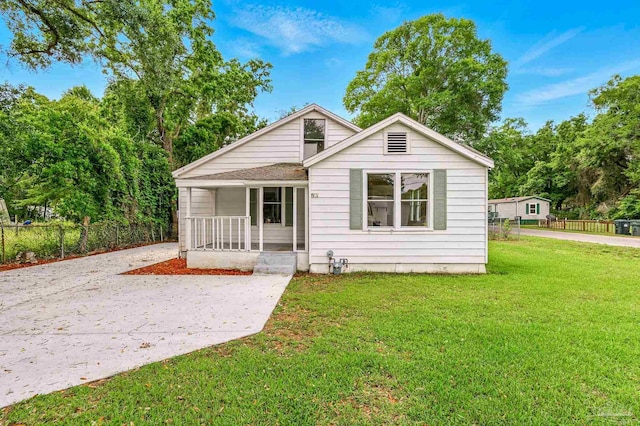 view of front of home with fence, a porch, and a front yard