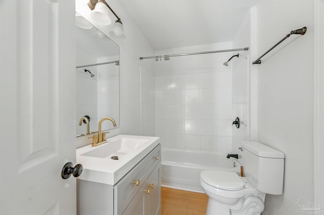 full bath featuring toilet, bathtub / shower combination, and vanity