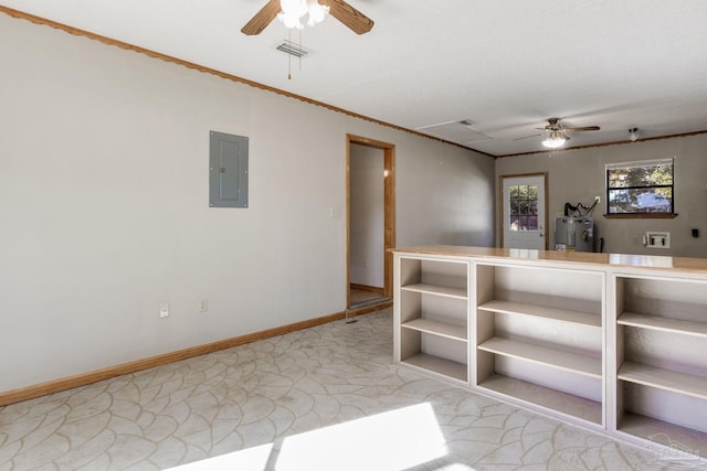 spare room with ceiling fan, ornamental molding, electric panel, and water heater