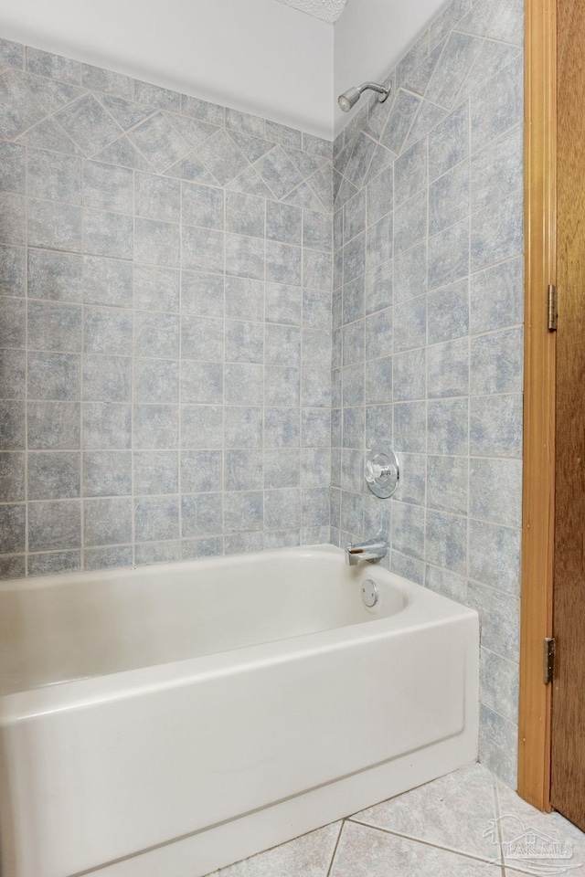 bathroom featuring tile patterned flooring and shower / washtub combination