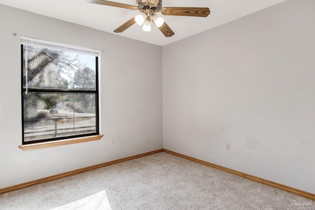 carpeted spare room featuring ceiling fan