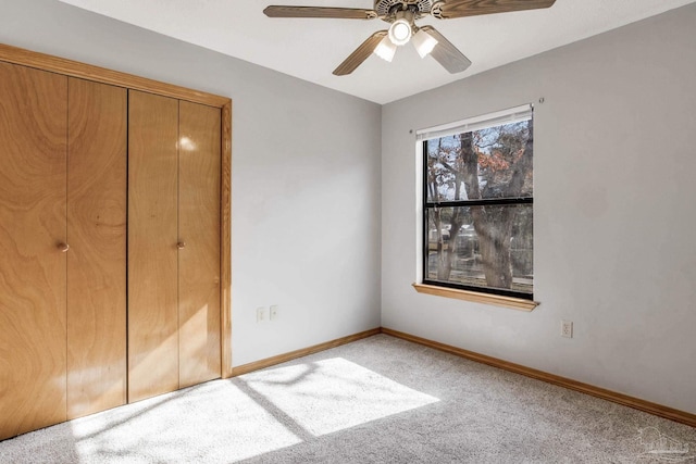 unfurnished bedroom featuring carpet floors, ceiling fan, and a closet