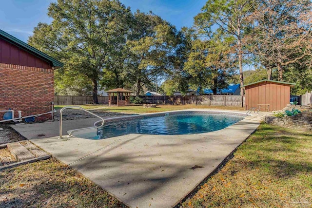 view of pool featuring a gazebo, a storage unit, a patio area, and a lawn