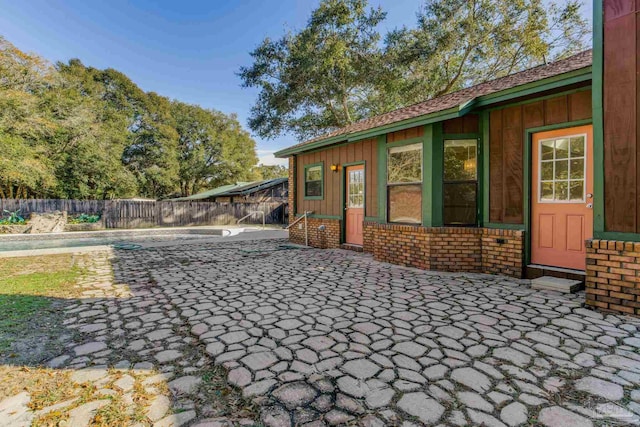 exterior space featuring a fenced in pool and a patio