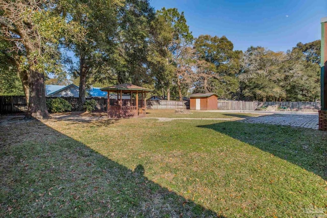 view of yard featuring a gazebo and a storage unit