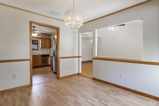 unfurnished room with crown molding, ceiling fan with notable chandelier, light hardwood / wood-style flooring, and a textured ceiling