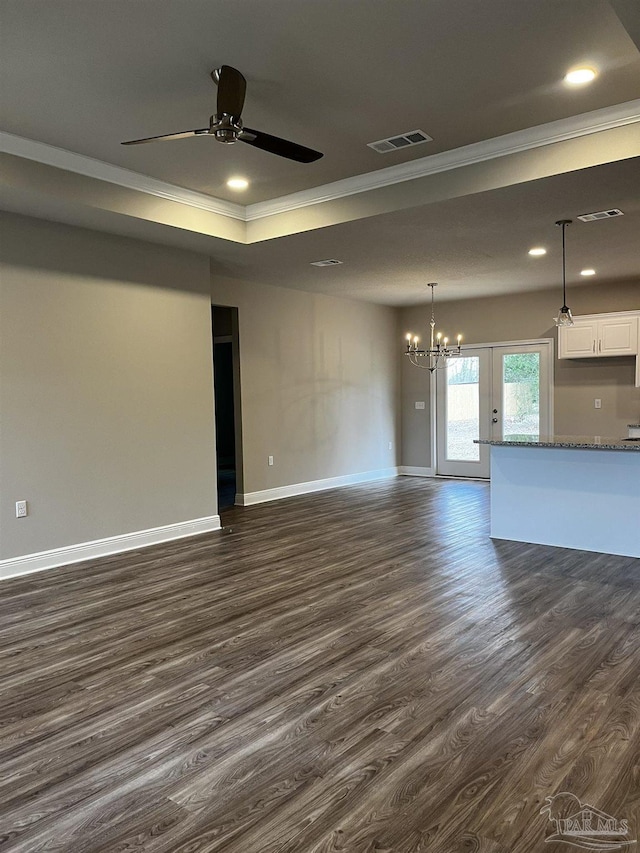 unfurnished living room featuring visible vents, baseboards, and dark wood-style flooring