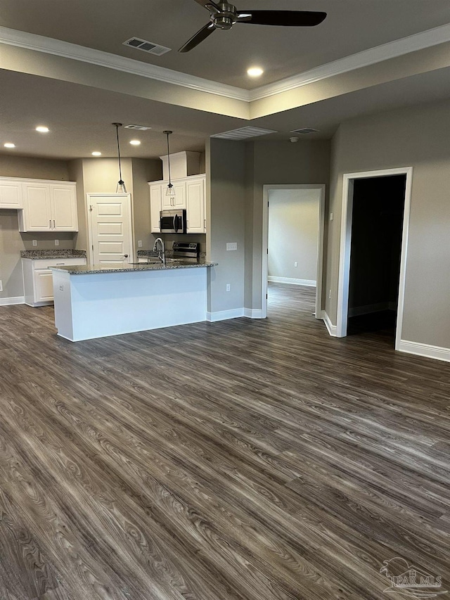 kitchen with stainless steel microwave, visible vents, baseboards, recessed lighting, and white cabinets