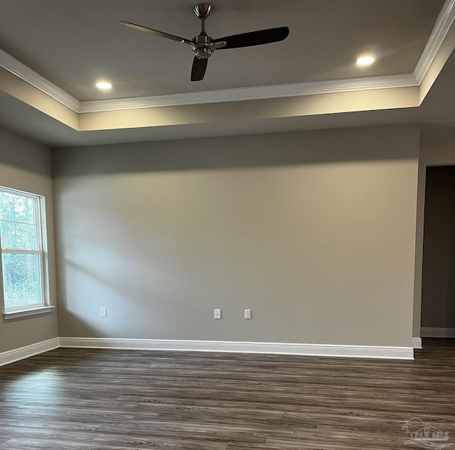 unfurnished room with dark wood-type flooring, baseboards, and ornamental molding