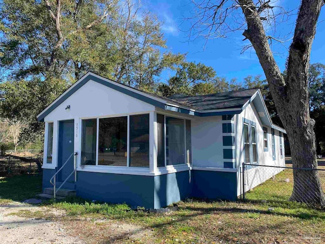 view of property exterior featuring a sunroom