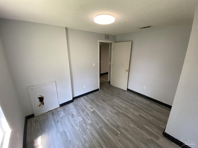 bedroom with multiple windows and a textured ceiling