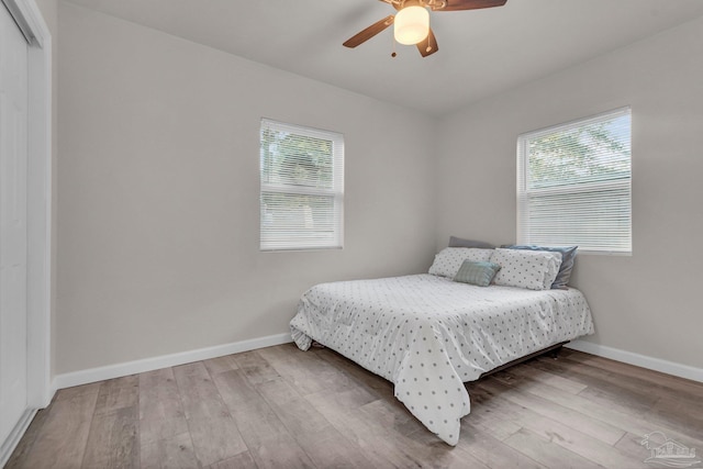 bedroom featuring hardwood / wood-style floors, ceiling fan, and a closet