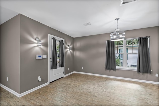 6609 Cedar St, Milton, FL 32570 - entryway featuring wood finished floors and a chandelier