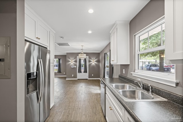 6609 Cedar St, Milton, FL 32570 - kitchen with appliances with stainless steel finishes, dark countertops, white cabinets, healthy amount of natural light, and recessed lighting