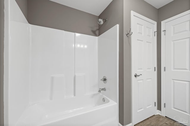 6609 Cedar St, Milton, FL 32570 - full bathroom featuring washtub / shower combination and wood finished floors