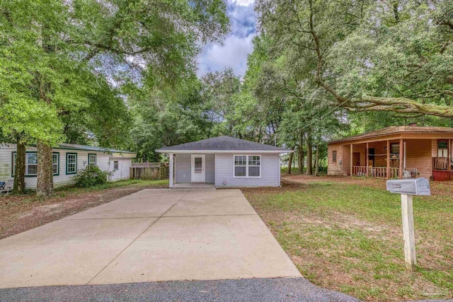 6609 Cedar St, Milton, FL 32570 - view of front of house featuring covered porch and a front yard