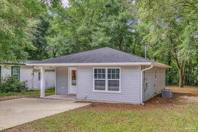 6609 Cedar St, Milton, FL 32570 - view of front facade featuring a patio area, roof with shingles, and view of scattered trees