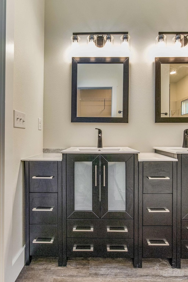 bathroom with vanity and hardwood / wood-style flooring