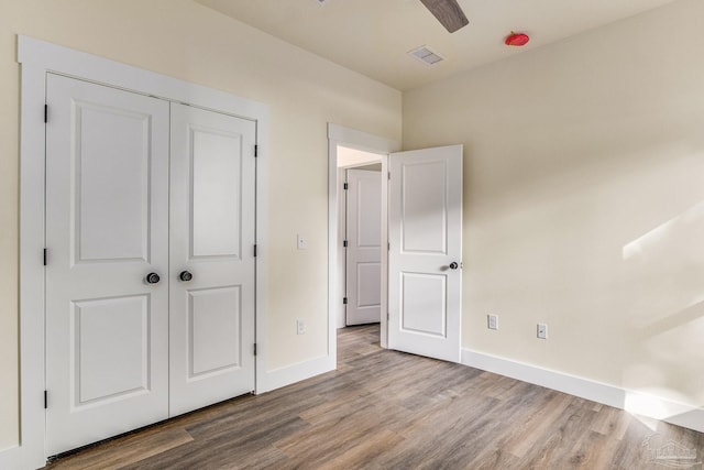 unfurnished bedroom with ceiling fan, light hardwood / wood-style floors, and a closet