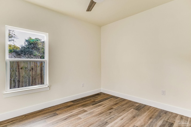 empty room featuring wood-type flooring and ceiling fan