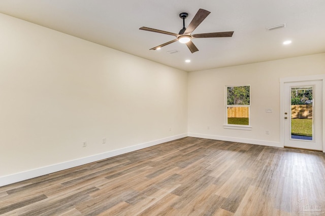 spare room featuring ceiling fan and light wood-type flooring