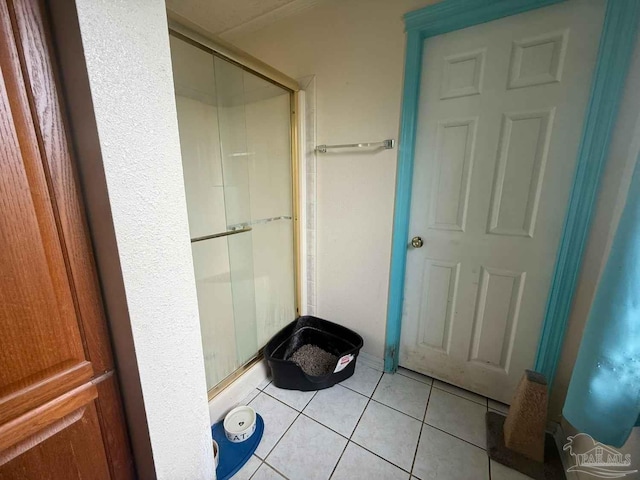 bathroom featuring a shower stall and tile patterned flooring
