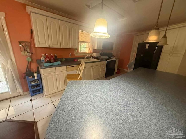 kitchen with dark countertops, hanging light fixtures, a sink, and light tile patterned floors