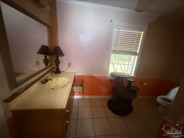 bathroom featuring crown molding, toilet, tile patterned flooring, vanity, and baseboards