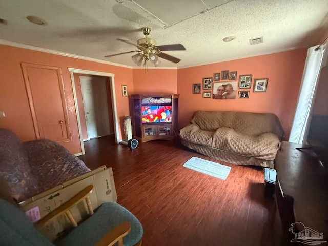living area featuring wood finished floors, a ceiling fan, a textured ceiling, and crown molding