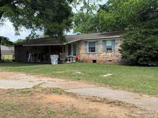 view of front of house with crawl space, a front lawn, and brick siding