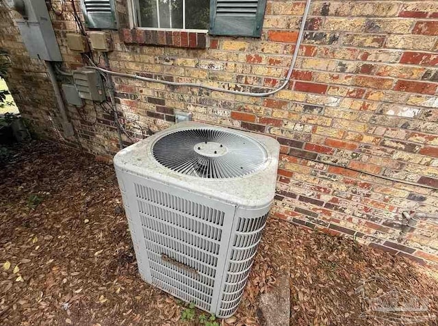 exterior view of cooling unit and brick siding