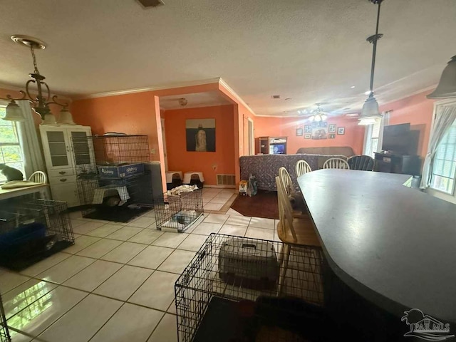 dining space with light tile patterned floors and ornamental molding