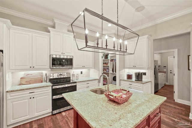 kitchen featuring an island with sink, sink, white cabinetry, appliances with stainless steel finishes, and dark hardwood / wood-style flooring