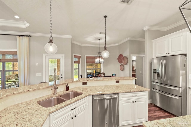 kitchen featuring stainless steel appliances, white cabinetry, dark wood-type flooring, and a healthy amount of sunlight