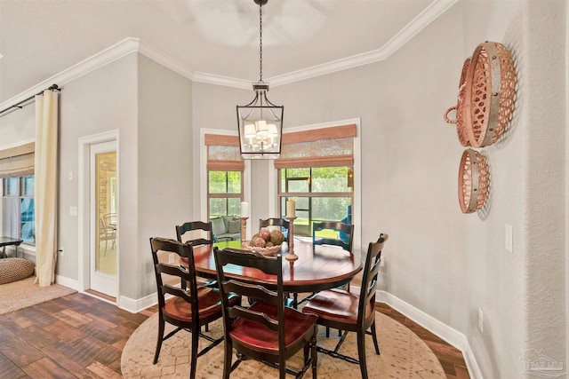 dining space with crown molding, hardwood / wood-style floors, and a chandelier