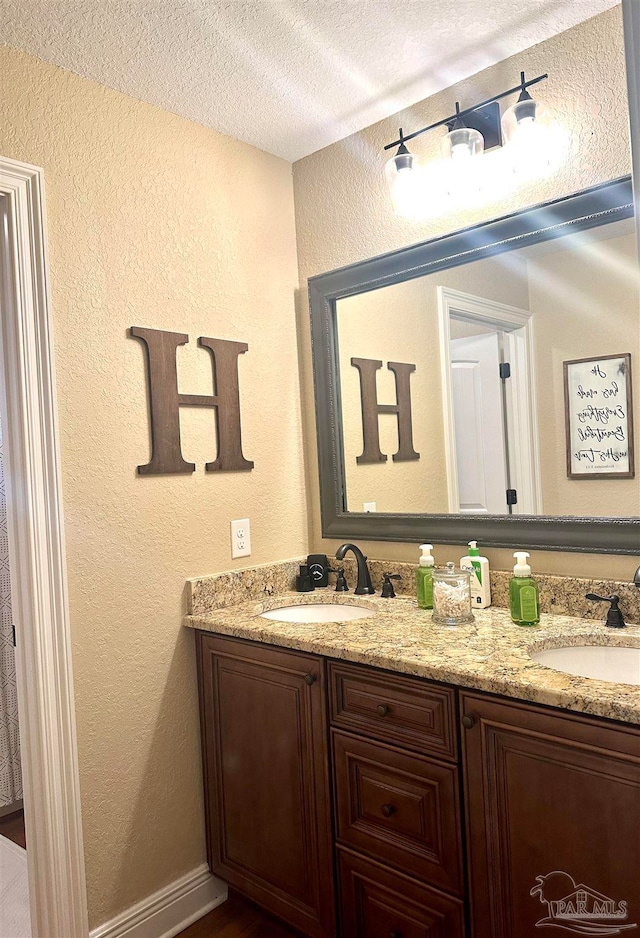 bathroom with vanity and a textured ceiling