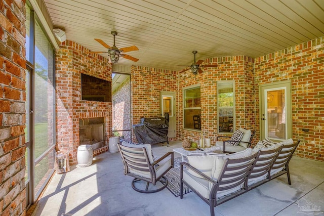 view of patio featuring an outdoor living space with a fireplace and ceiling fan