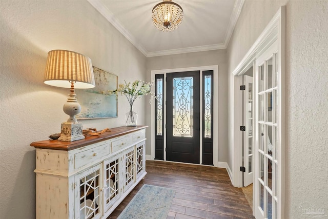 entrance foyer with an inviting chandelier, crown molding, and dark hardwood / wood-style flooring