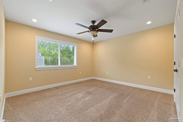 carpeted spare room with ceiling fan