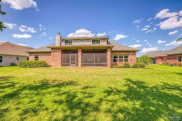 back of house with a sunroom and a lawn