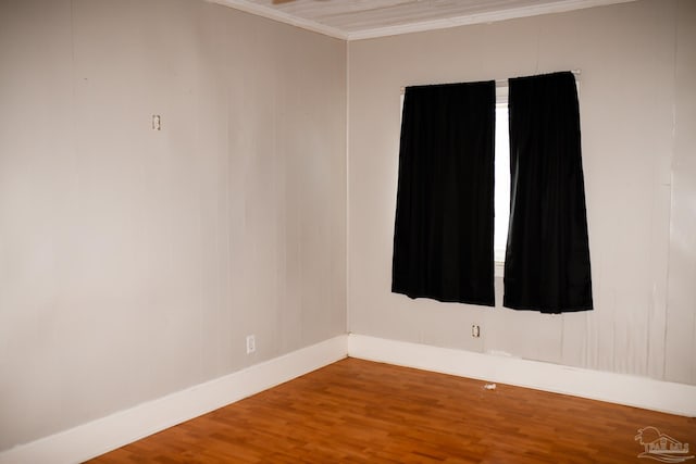 unfurnished room featuring hardwood / wood-style floors and ornamental molding