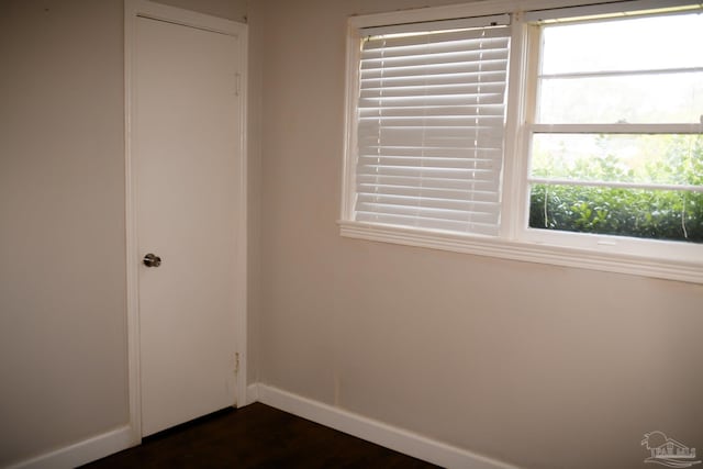 spare room with dark hardwood / wood-style flooring