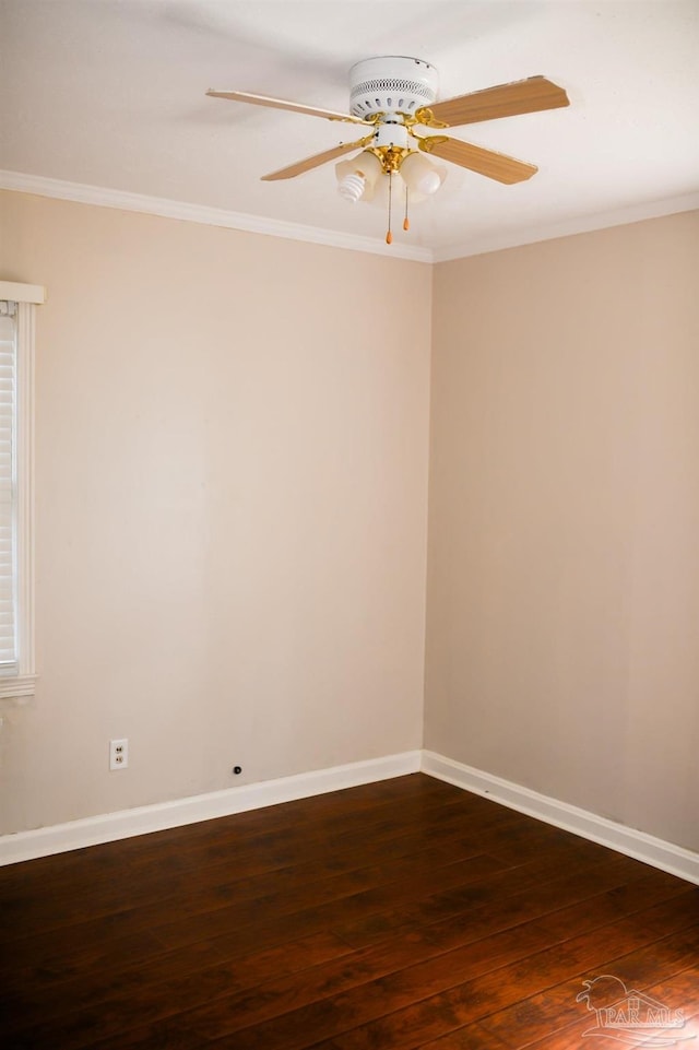 spare room featuring dark hardwood / wood-style floors and ornamental molding