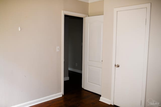 unfurnished bedroom featuring dark wood-type flooring