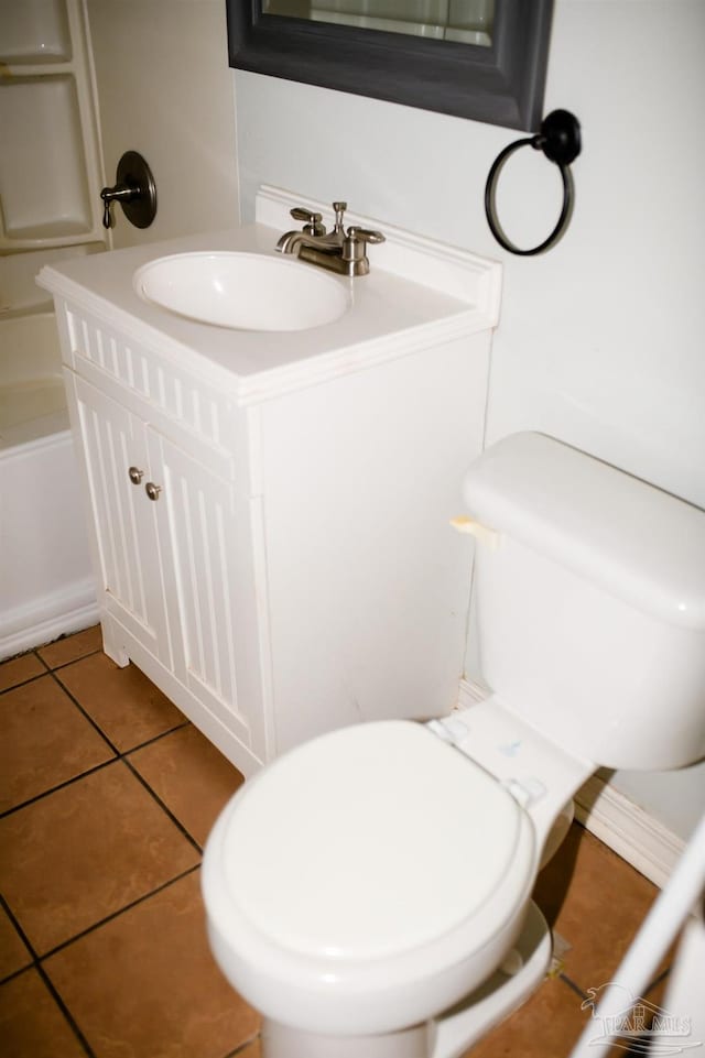 bathroom featuring tile patterned flooring, vanity, and toilet