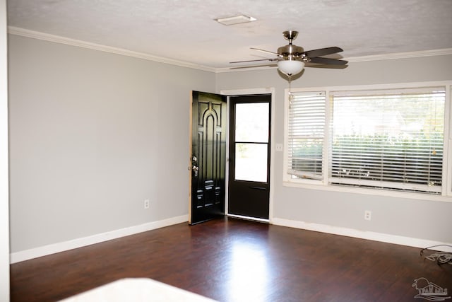 entryway with a textured ceiling, dark hardwood / wood-style flooring, ceiling fan, and crown molding