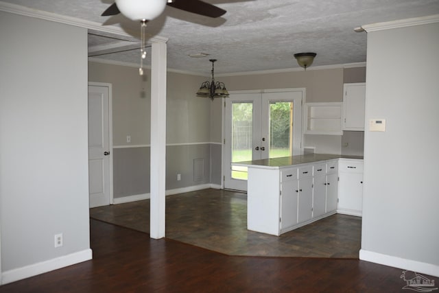 kitchen featuring white cabinets, dark hardwood / wood-style flooring, ornamental molding, and french doors