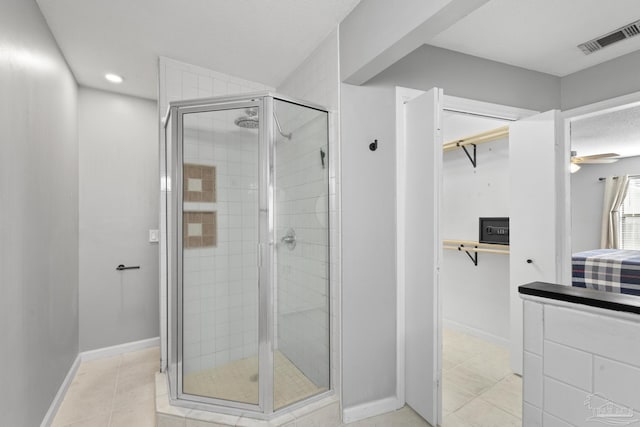 bathroom with ceiling fan, tile patterned flooring, and an enclosed shower